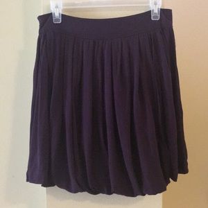 Deep purple pleated skirt.